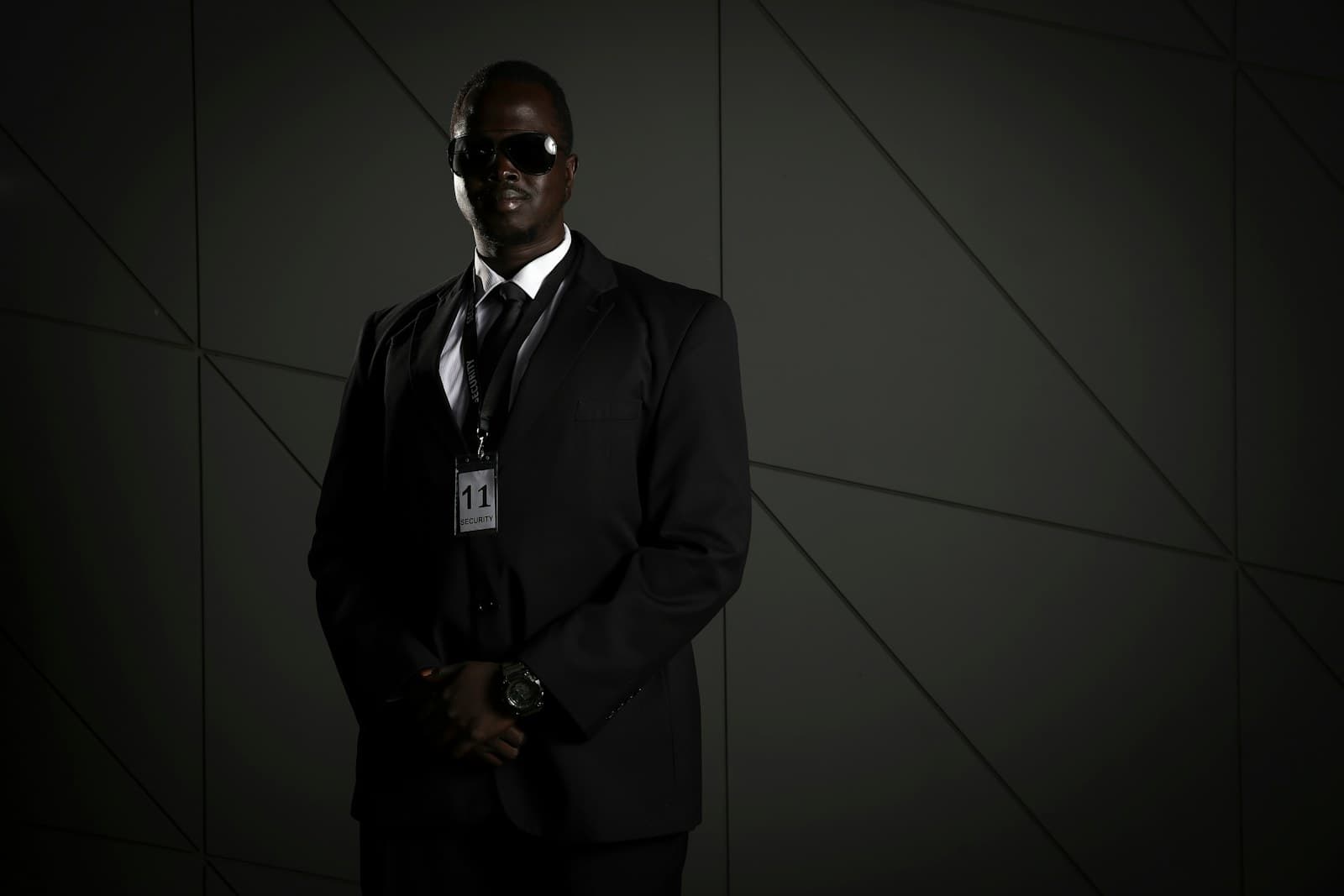 Close protection officer in dark suit — vetted Mac Dominus security personnel
